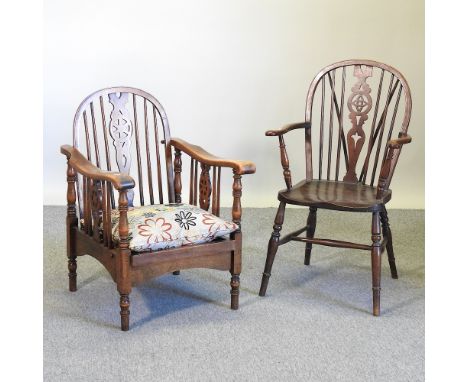 A wheelback open armchair, together with an oak wheelback reclining chair, with cushion (2)