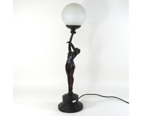 An Art Deco style figural table lamp, with a globe shade, 68cm high