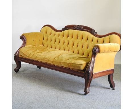 A large Victorian mahogany and yellow upholstered show frame sofa, 220cm