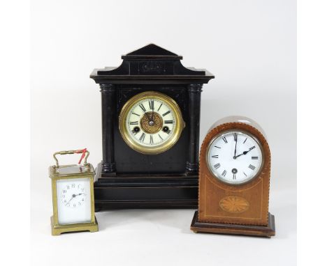 An early 20th century brass cased carriage clock, 10cm, together with an Edwardian mantel  clock, a Victorian ebonised mantle