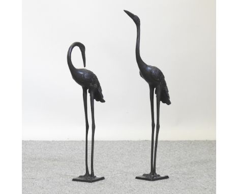 A bronzed model of a heron, 60cm, together with another smaller