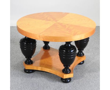 An Art Deco continental Biedermeier style maple and ebonised occasional table, with a circular radially veneered top, on bulb