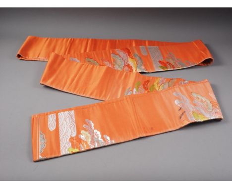 A Japanese orange silk sash, embroidered trees and clouds 