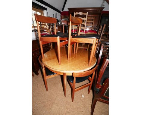 A G-Plan teak circular dining table with one integral extra leaf, 48" dia when closed, and a matched set of six standard dini