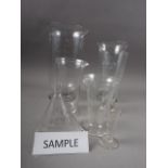 A collection of chemist's flasks and measuring jars, etc