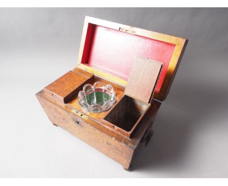 An early Victorian burr yew tea caddy with ring handles, the interior fitted with two compartments and glass mixing bowl, on 