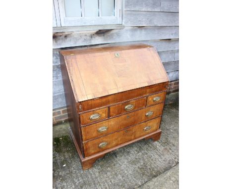 An early 18th century walnut and fruitwood line inlaid fall front bureau, the interior fitted pigeonholes, drawers and well, 