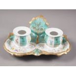 A late 19th century French porcelain desk inkstand with two wells and floral and gilt decoration,