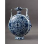 A Chinese porcelain blue and white moon flask with all-over geometric and scroll decoration, 8" high
