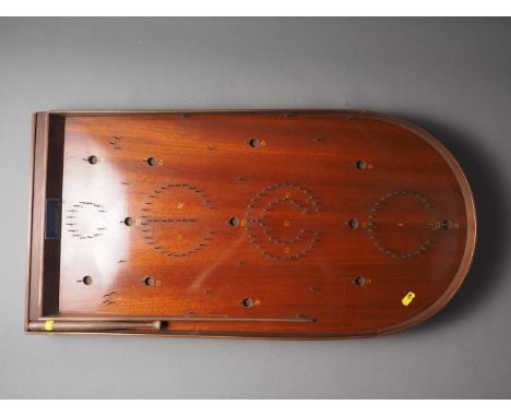 An early 20th century mahogany Holey Bogey Corinthian Bagatelle board with ball bearings and push stick, 30" long 