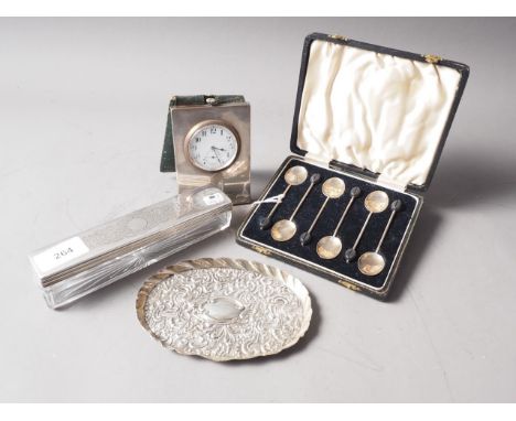 A silver cased travelling clock with leather folding cover, (damages), a set of six silver coffee spoons, a silver tray with 