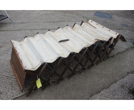 A WWI camp bed, in oak cabinet, said to have belonged to S M De H Whatton DSO MC,&nbsp;32" wide x 12" deep x 21" high (damage