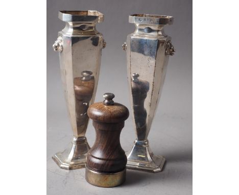 A pair of silver vases with lion mask handles, 7.7oz troy approx, and a turned wood and silver mounted pepper grinder 
