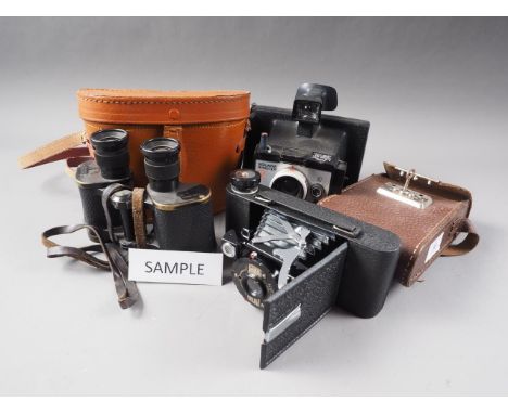 A Kershaw Eight-20 Penguin folding camera, in leather case, a Polaroid Square Shooter 2 Land Camera, a pair of Kershaw &amp; 