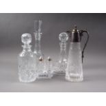 A Waterford cut glass decanter, a ship's decanter, three other decanters, a claret jug with plated