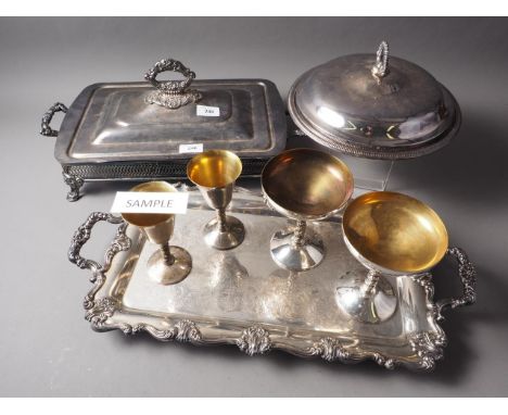 A silver plated two-handled tray, a plated dish stand, a collection of plated champagne flutes and other plate 