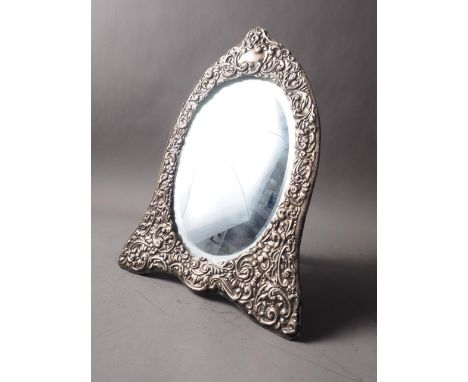 A silver framed easel mirror with scrolled decoration and bevelled plate, 12 1/2" high overall, and a similar silver plated p
