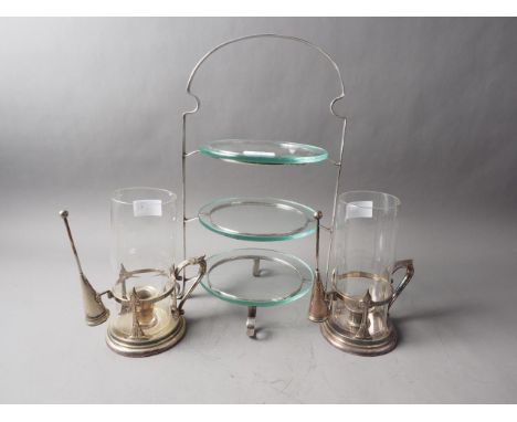 A pair of storm lanterns with silver plated mounts and a plated three-tier cakestand 