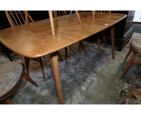 An Ercol natural elm "slide leg expanding" dining table with two extra leaves, 60" wide x 33" deep x 28" high, both leaves ar