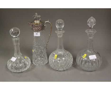 A silver plate mounted and cut glass claret jug with lion finial, 12 1/2" high, and three clear glass decanters 