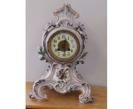 A 19thC French rococo style porcelain cased mantel clock with eight day striking movement.