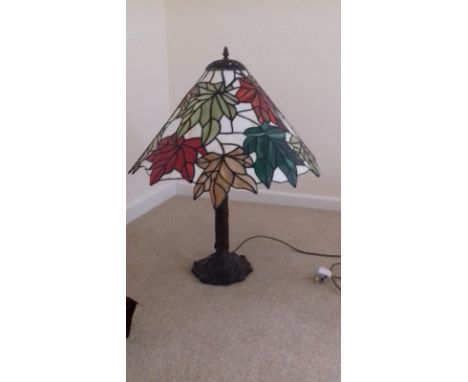 A modern reproduction Tiffany style leaded light table lamp in Maple Leaf Pattern, on bark patinated base, 28” overall height
