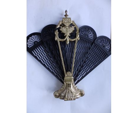 A reproduction style brass 'fan' firescreen.