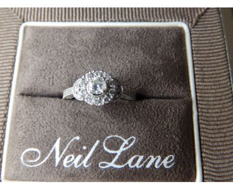 A modern diamond cluster ring by Neil Lane. Finger size K.