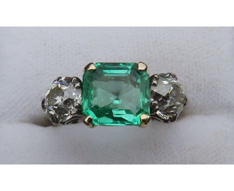 An art deco three stone emerald &amp; diamond ring, the square cut emerald weighing approximately 3 carats in four-claw setti