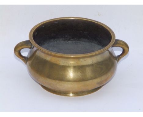 A Chinese bronze two-handled censer, cast with a six-character reign mark to underside within a roundel depicting two dragons
