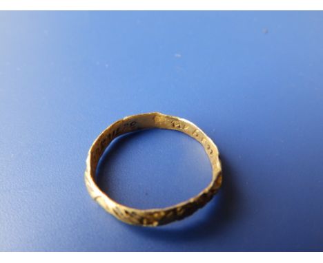 An antique gold posy ring, the exterior crudely decorated with hands holding a heart, the interior engraved ' When this you s