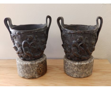 A pair of 19thC Renaissance revival bronze urns on stone bases, 6.75” high. (2)