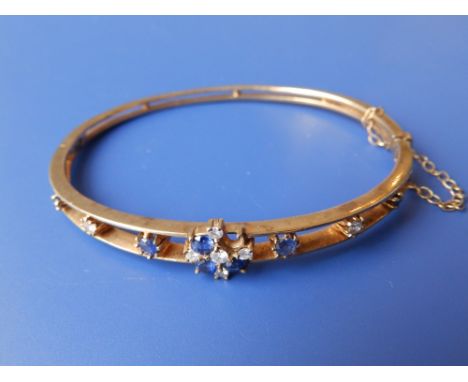 A 9ct bangle – stone missing.