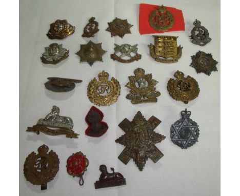 21 British military cap badges from various regiments including Artillery, Royal Engineers, Army Ordnance Corp., East Surrey,