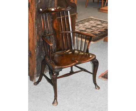 A George II Style Elm Comb Back Windsor Chair, on pad feet with dished seat66cm by 50cm by 100cmSeat height - 43cmFront right