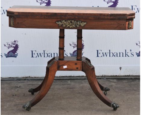 Early 19th century mahogany fold over top card table with gilt metal mounts and lions paw castors, on four column base with s
