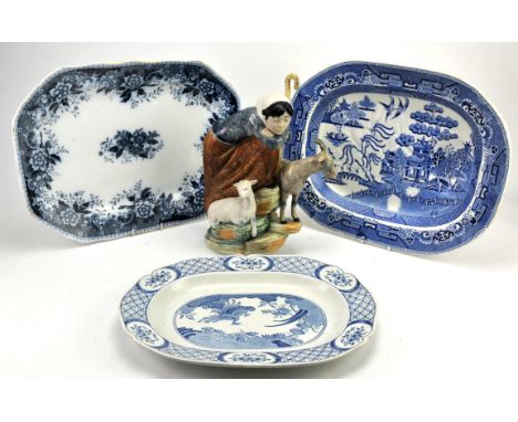 A Nao figure of a shephard with animals in attendance and three blue and white meat dishes. 