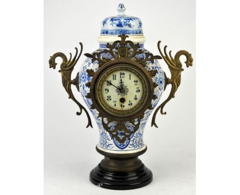 A Black forest style cuckoo clock with weights, 35cm high, together with a Dutch delft ceramic clock, early 20th Century, an 