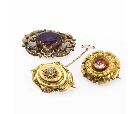 Two Victorian gold memorial brooches,comprising a gold foiled glass cabochon memorial brooch, a circular foiled glass cabocho