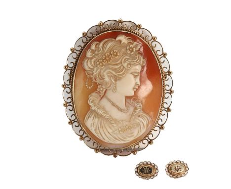 A large gold carved shell cameo brooch,an oval carved shell cameo, depicting a lady with floral details, bezel set to a plain