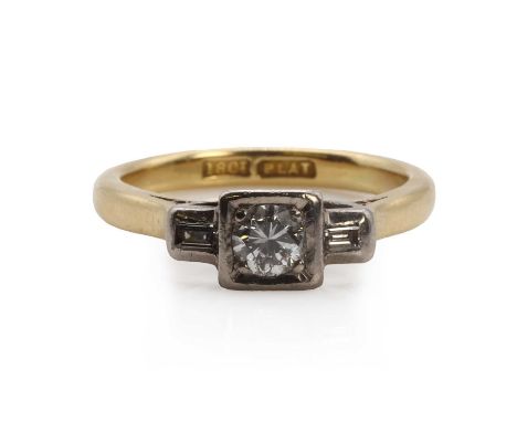 A gold and platinum round brilliant cut diamond ring with baguette diamond accents,a round brilliant cut diamond, estimated a