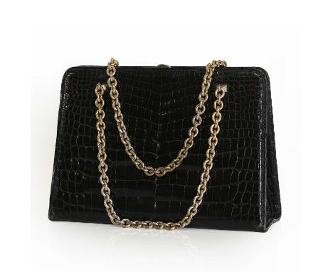A Gucci vintage crocodile embossed handbag,with gold tone chain and clasp closure, sectioned interior with zip and slip pocke