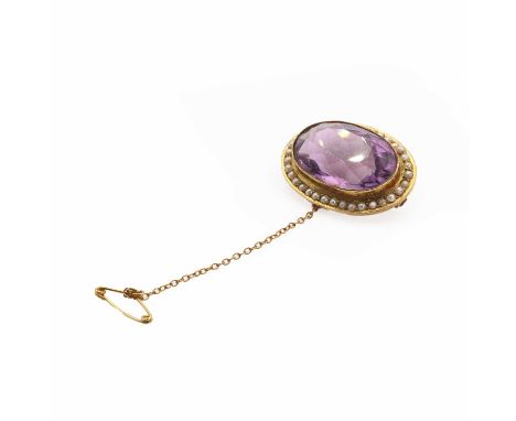 An Edwardian amethyst and split pearl brooch,an oval mixed cut amethyst millegrain set to a plain bezel, encircled by a line 