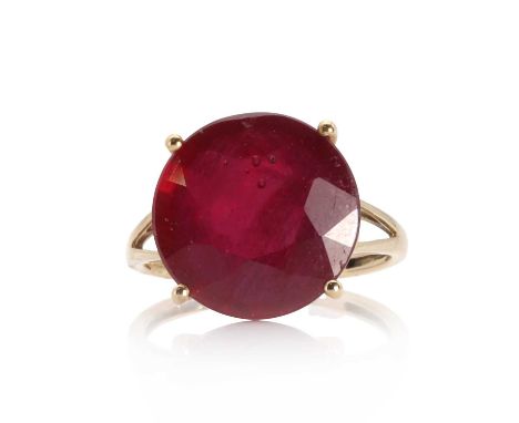 A 9ct gold single stone glass filled ruby ring, with a circular mixed cut ruby with a stated weight of 12.90ct. Glass filled,