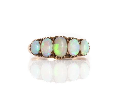 A five stone opal ring, five graduated oval cabochon opals all claw set to a scalloped gallery, to solid shoulders and a 'D' 