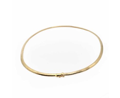 A gold omega chain,with a partially concealed box clasp with a single figure of eight catch. Marked 14K and tested as approxi