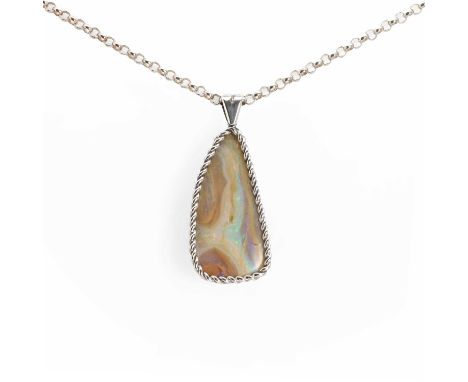 A silver boulder opal pendant, a free form boulder opal within a twisted and plain wire frame, 43mm x 20mm, suspended by a si