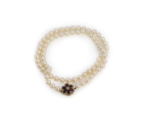 A single row uniform pearl necklace with an amethyst and seed pearl cluster style clasp,seventy-two uniform cultured pearls, 