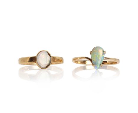 Two opal rings, comprising a gold ring set with a pear cabochon opal, to a crossover design band, tested as approximately 14c