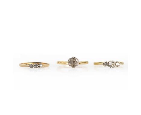 Two small diamond rings,the first a flowerhead cluster with seven single cut diamonds in a millegrain setting of white on yel